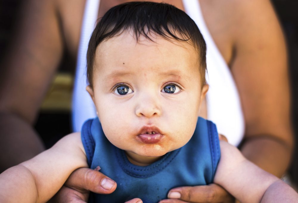 Happy baby boy on summer day