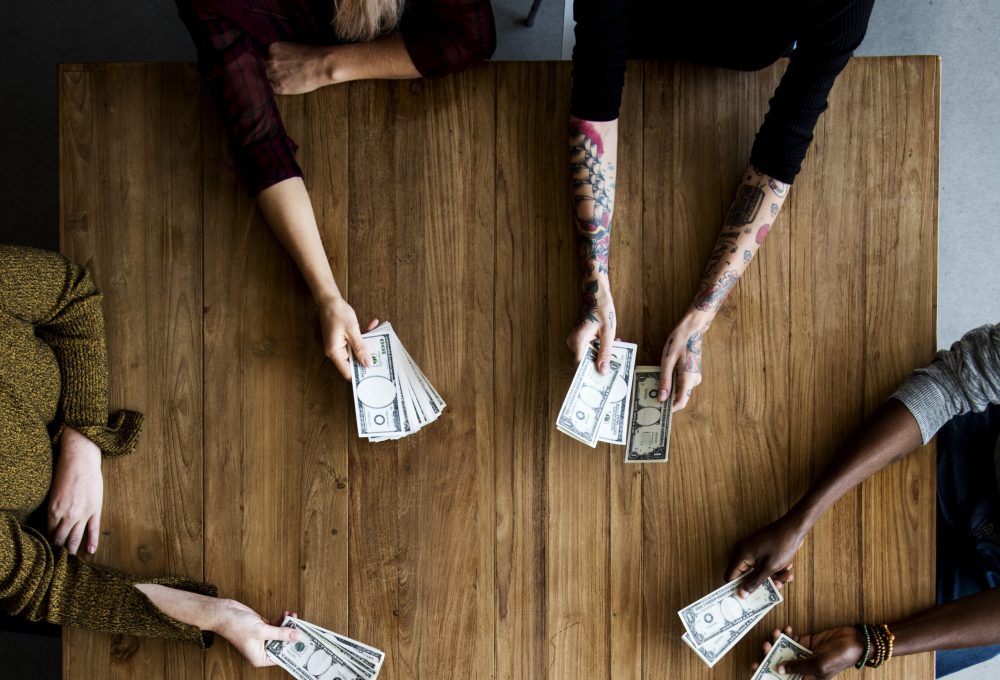 Diverse People Hands Hold Money Bill